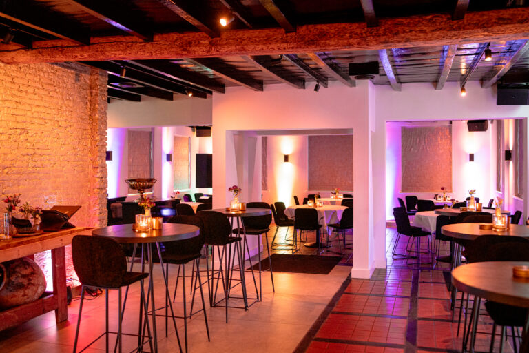 Sfeervolle zaal met houten balken en tafels